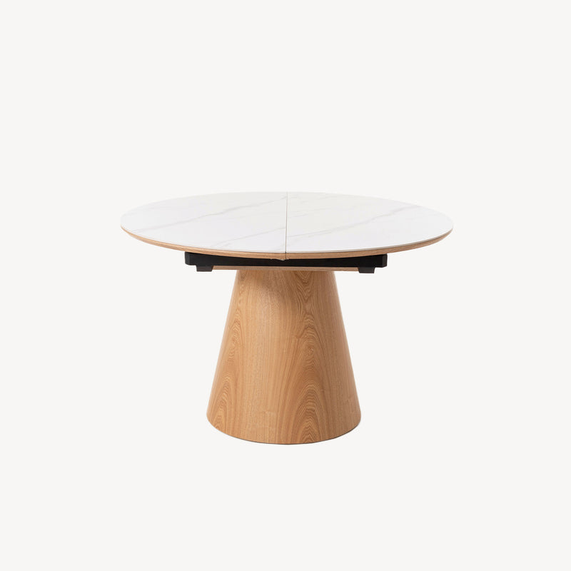 Mesa de comedor Sira extensible, tapa porcelánico blanco veteado efecto mármol, base troncocónica de roble natural. Estilo nórdico/moderno.
